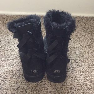 Black UGG boots with bows on the back